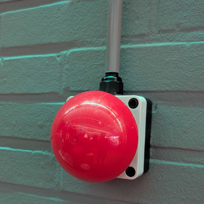 A physical Big Red override button mounted on the wall